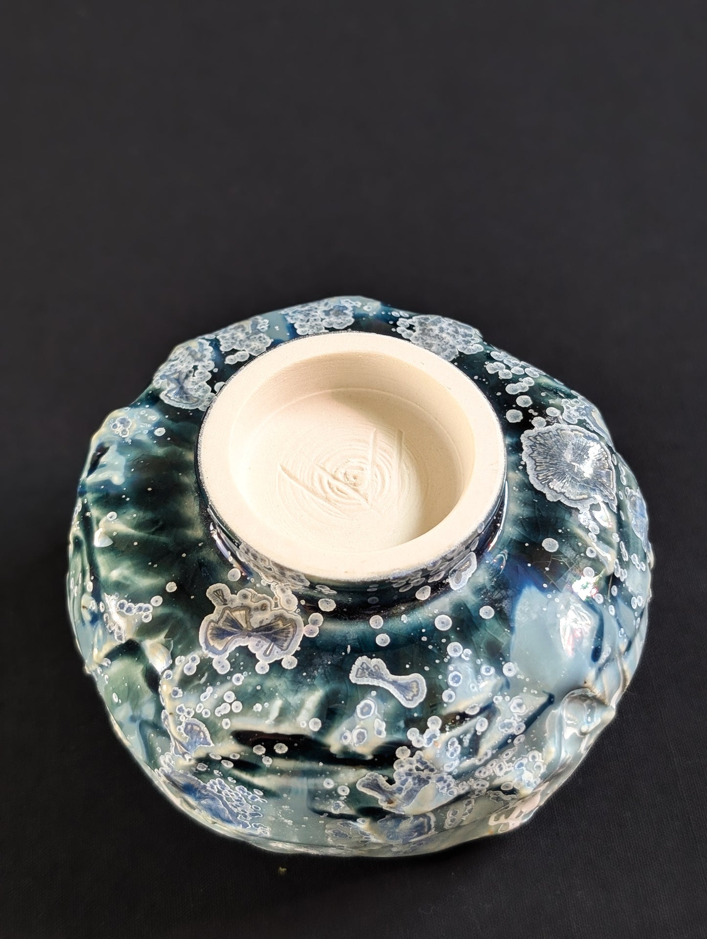 Underside of 'Caldera Bloom', with unglazed foot and Robbin Harris’s carved 'V' maker’s mark.