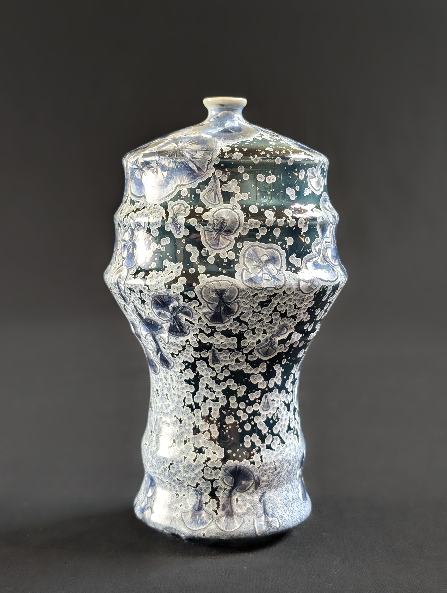 Ceramic vase with textured surface on a dark background