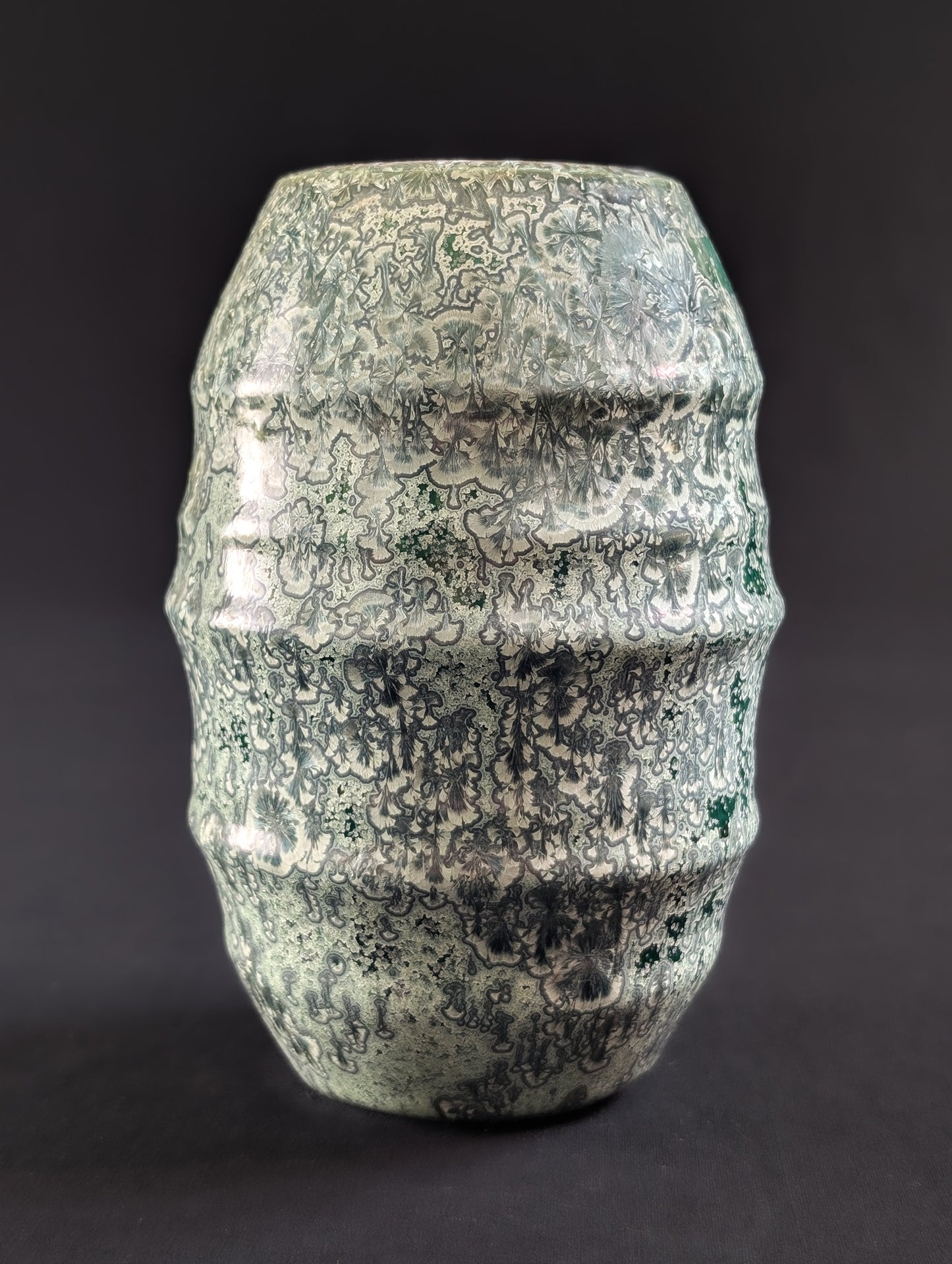 Crystalline vase by Canadian ceramic artist Robbin Harris against a dark background.