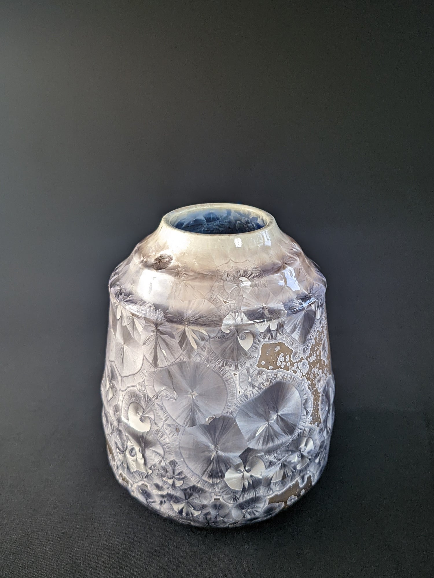 Soft Dawn Vase featuring delicate pastel pink and cream tones with a smooth, glossy finish and a subtle organic shape, set against a dark backdrop