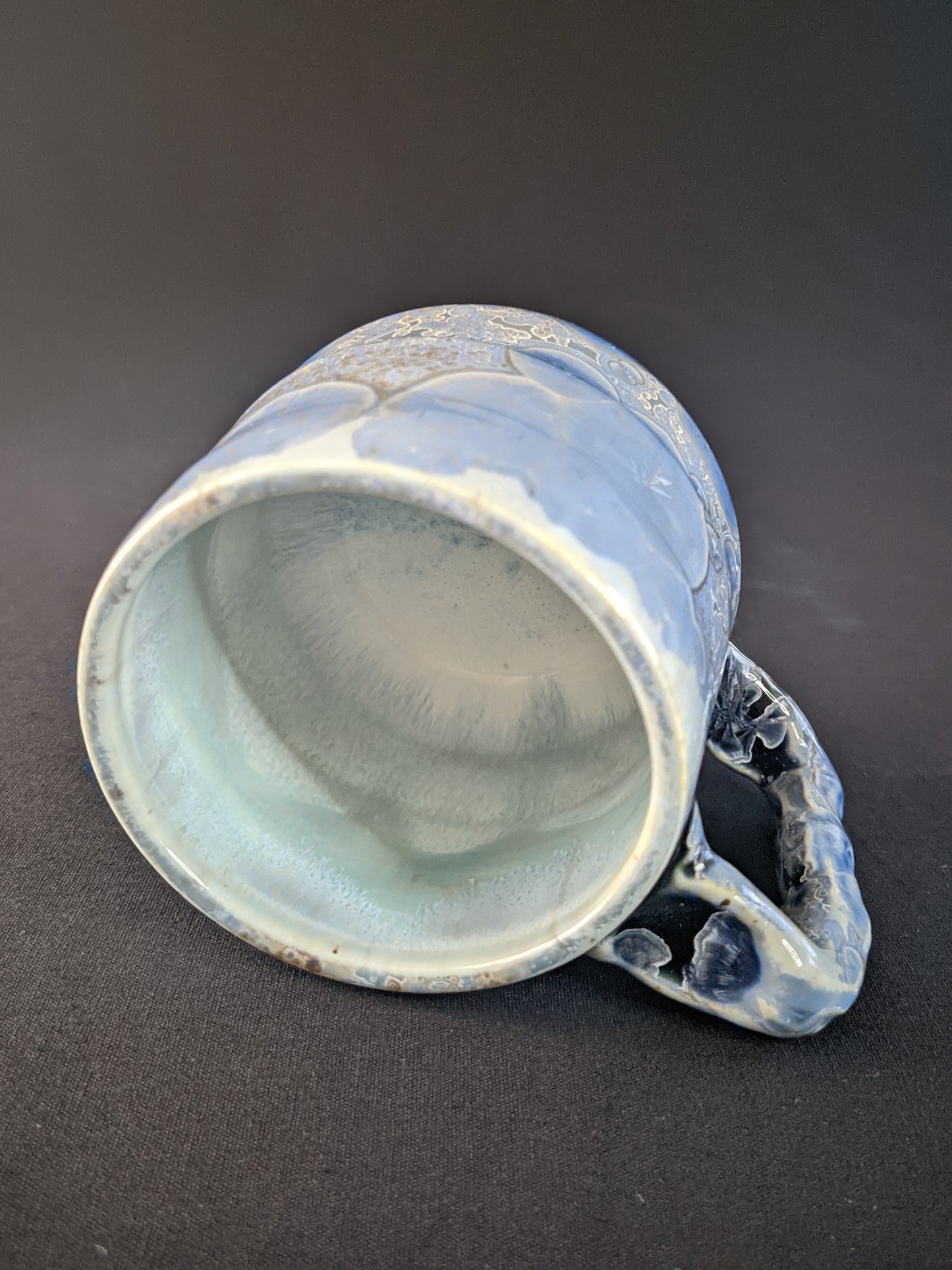 Handcrafted Glacial Echo Mug with a serene icy blue glaze, showcasing intricate frost-like textures, creating a cool, refreshing feel perfect for any drink.