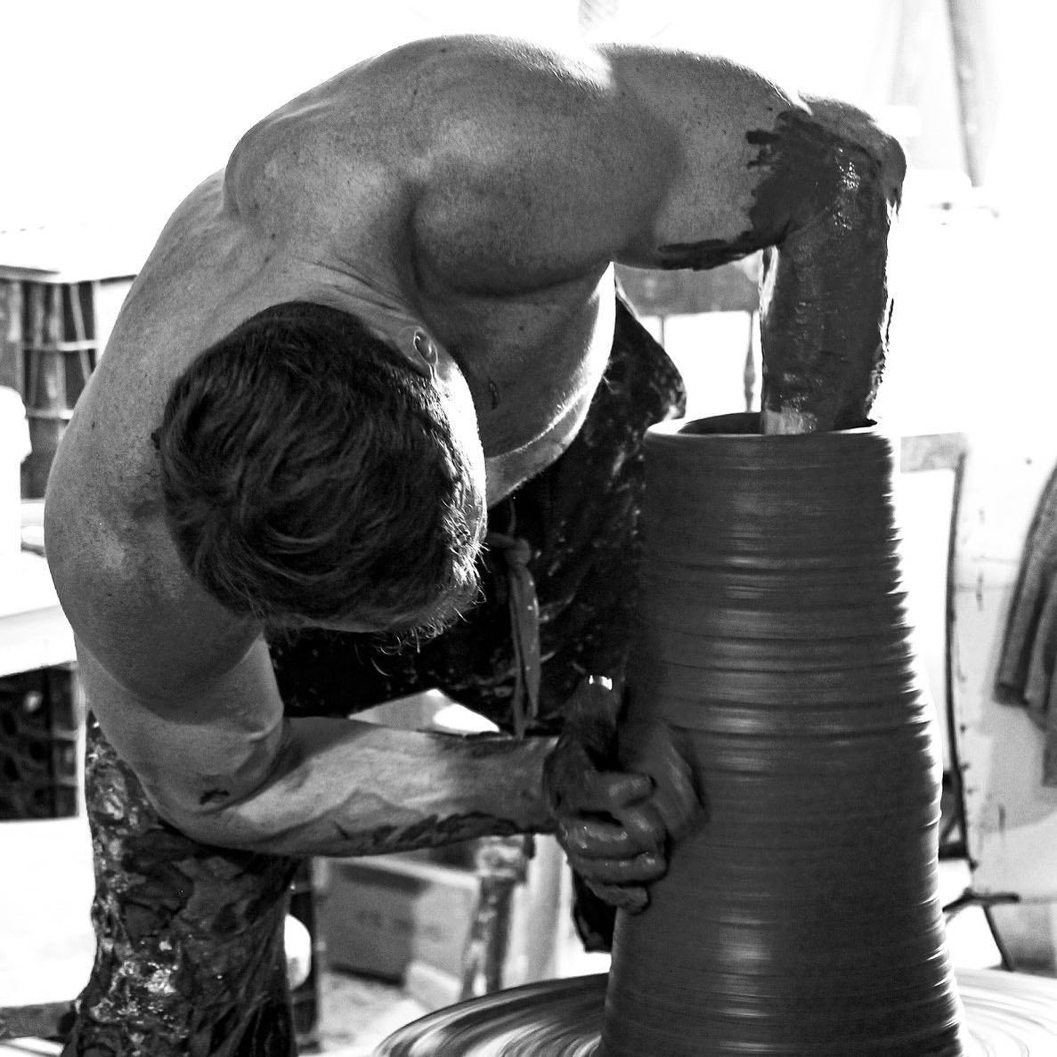 Robbin Harris in his studio, shaping an impressive ceramic piece with steady hands and deep concentration. A black and white photograph by David Marion.