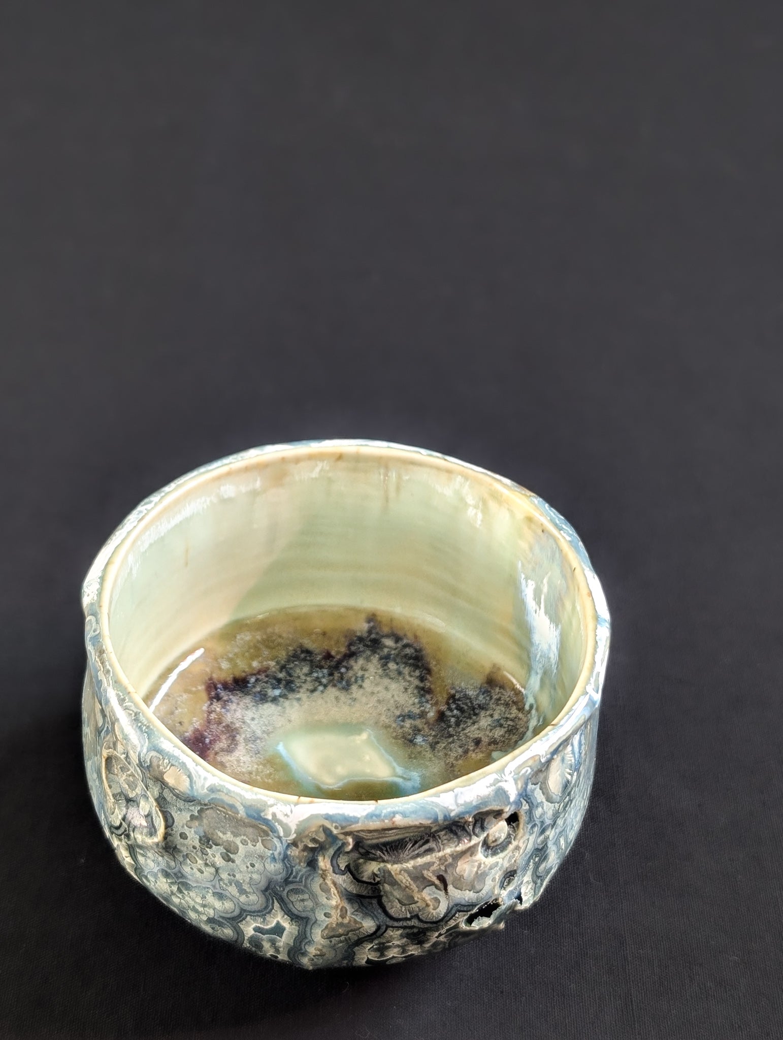 Interior of the 'Tetsuya' chawan, revealing contrast between the calm inner surface and dark, moody exterior.