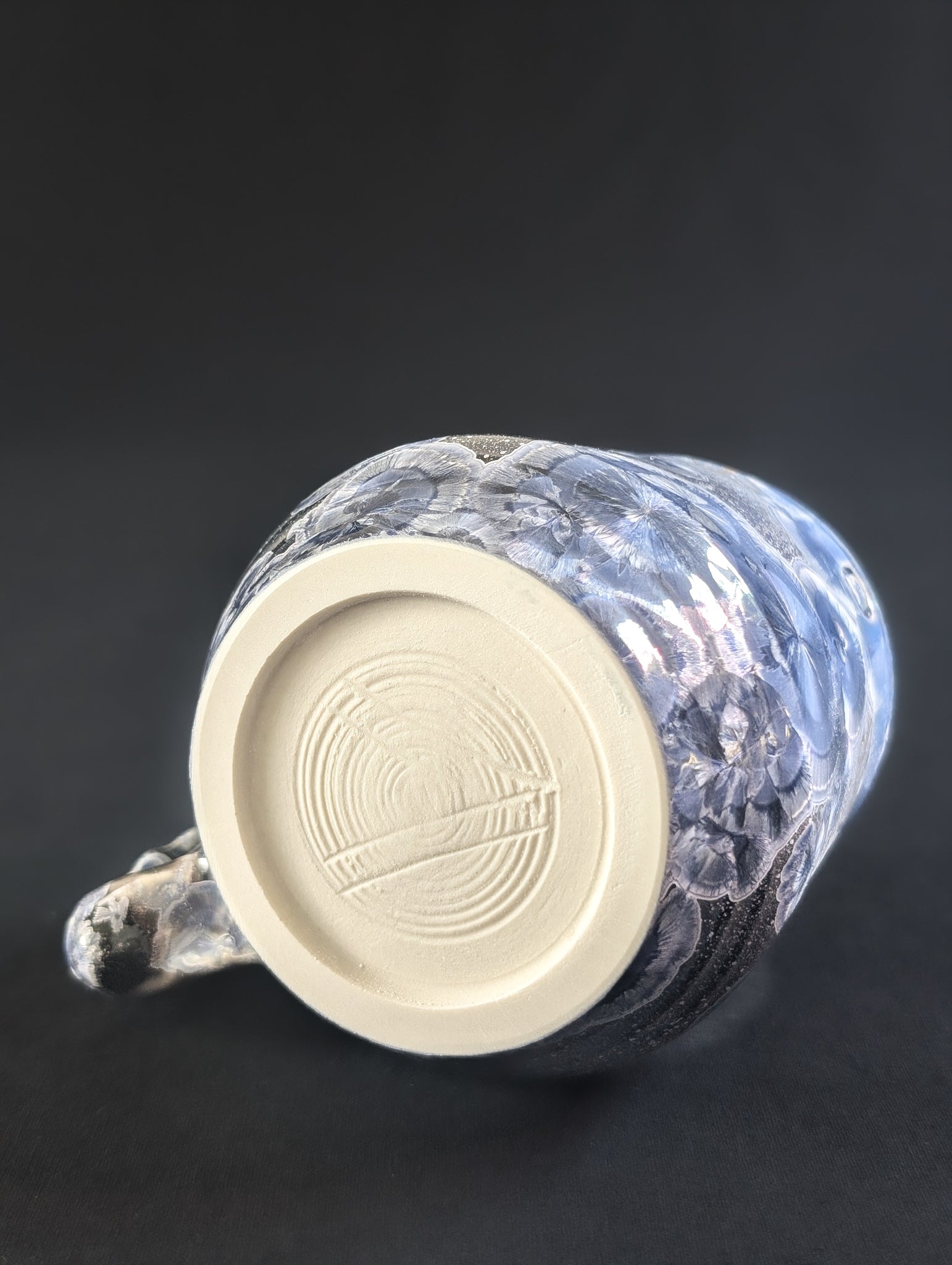 Bottom view of blue ceramic mug showing makers mark.