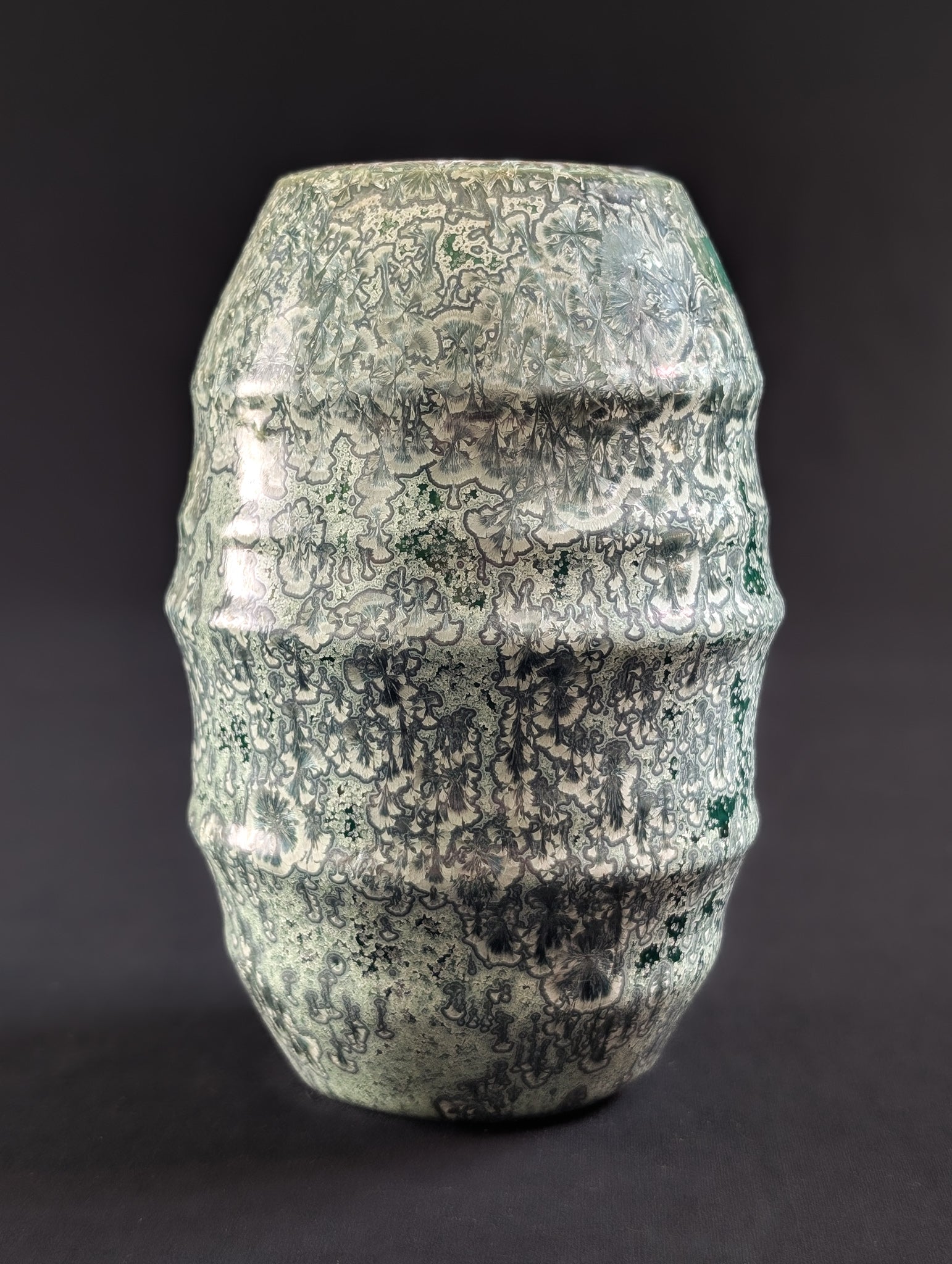 Crystalline vase by Canadian ceramic artist Robbin Harris against a dark background.