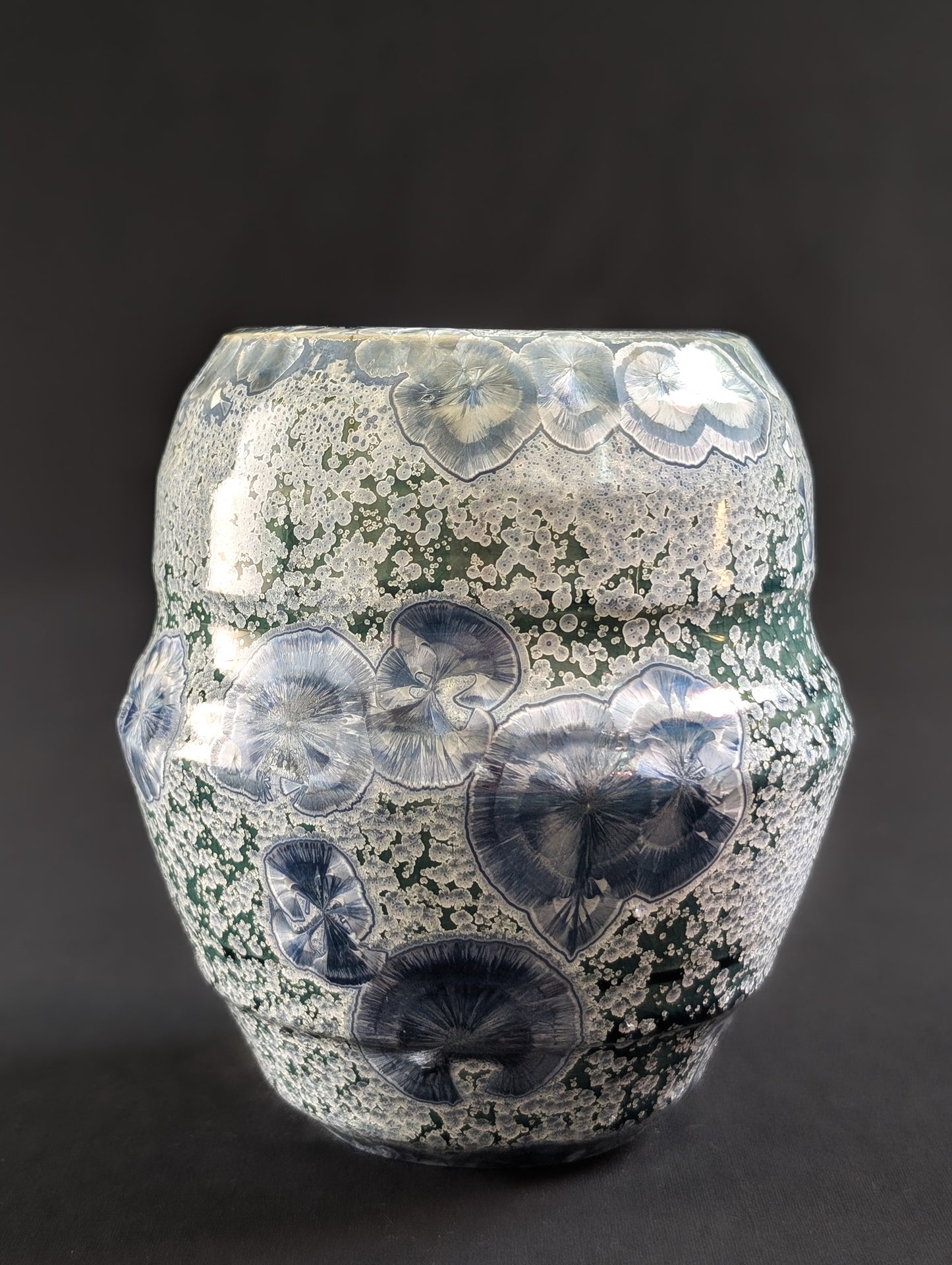 Frontal shot of 'Earth's Jewel' by ceramic artist Robbin Harris, featuring large sapphire crystals against an emerald green background.