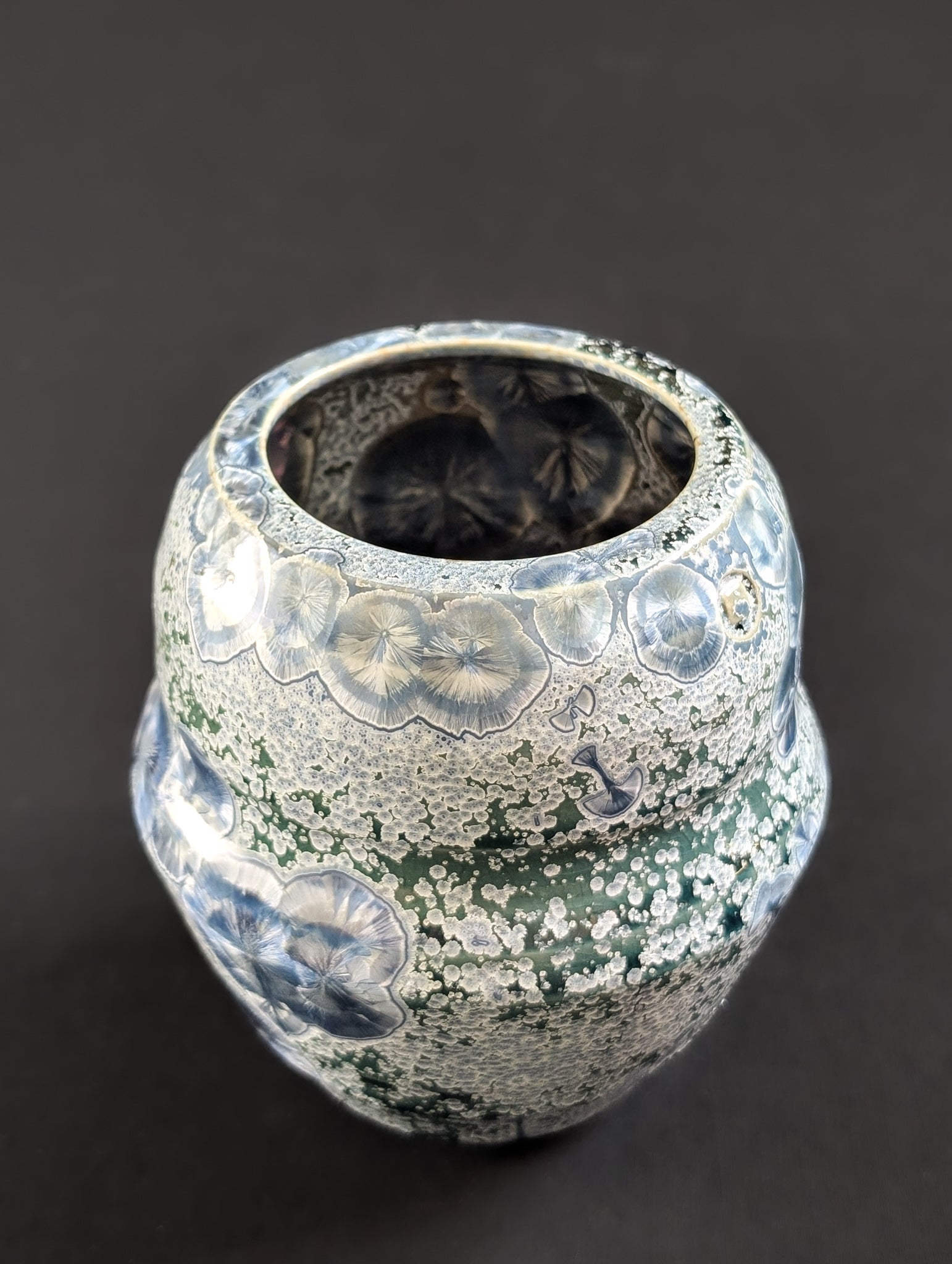 Angled view of Robbin Harris'  crystalline vase showing sapphire crystals even on the inside of this beautiful vase.