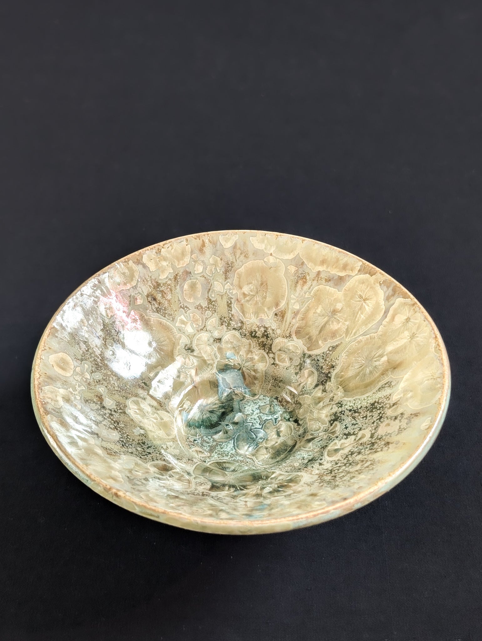 Top view of stunning crystalline ring dish with ochre yellow crystals and a hint of light green in the middle.
