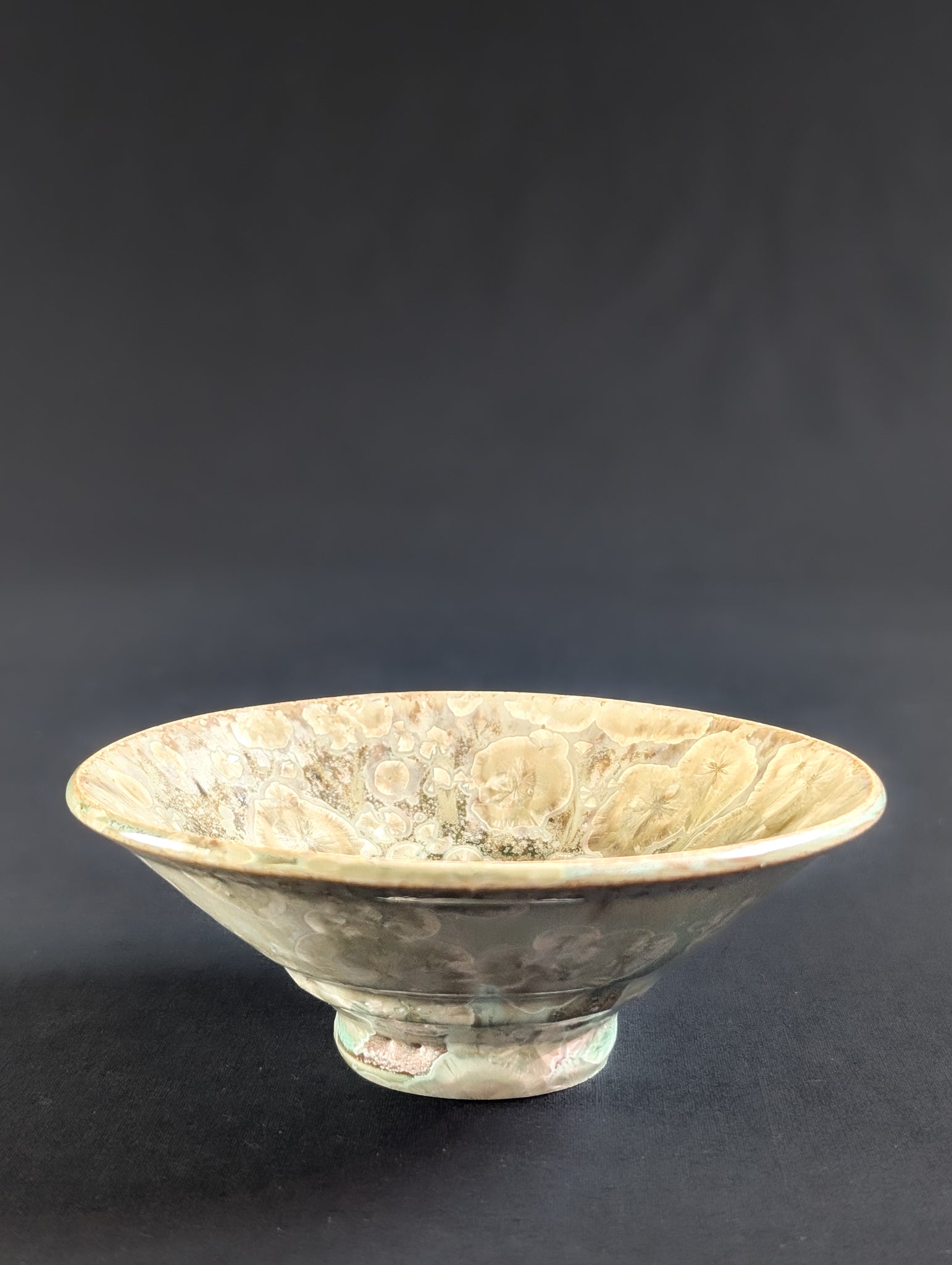 Front view of an ochre yellow ring dish by ceramic artist Robbin Harris.