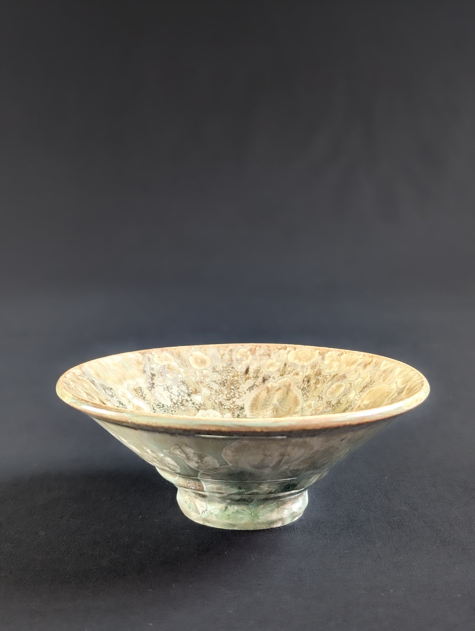 Porcelain trinket dish by Robbin Harris in ochre yellow with some hints of light green near the base.