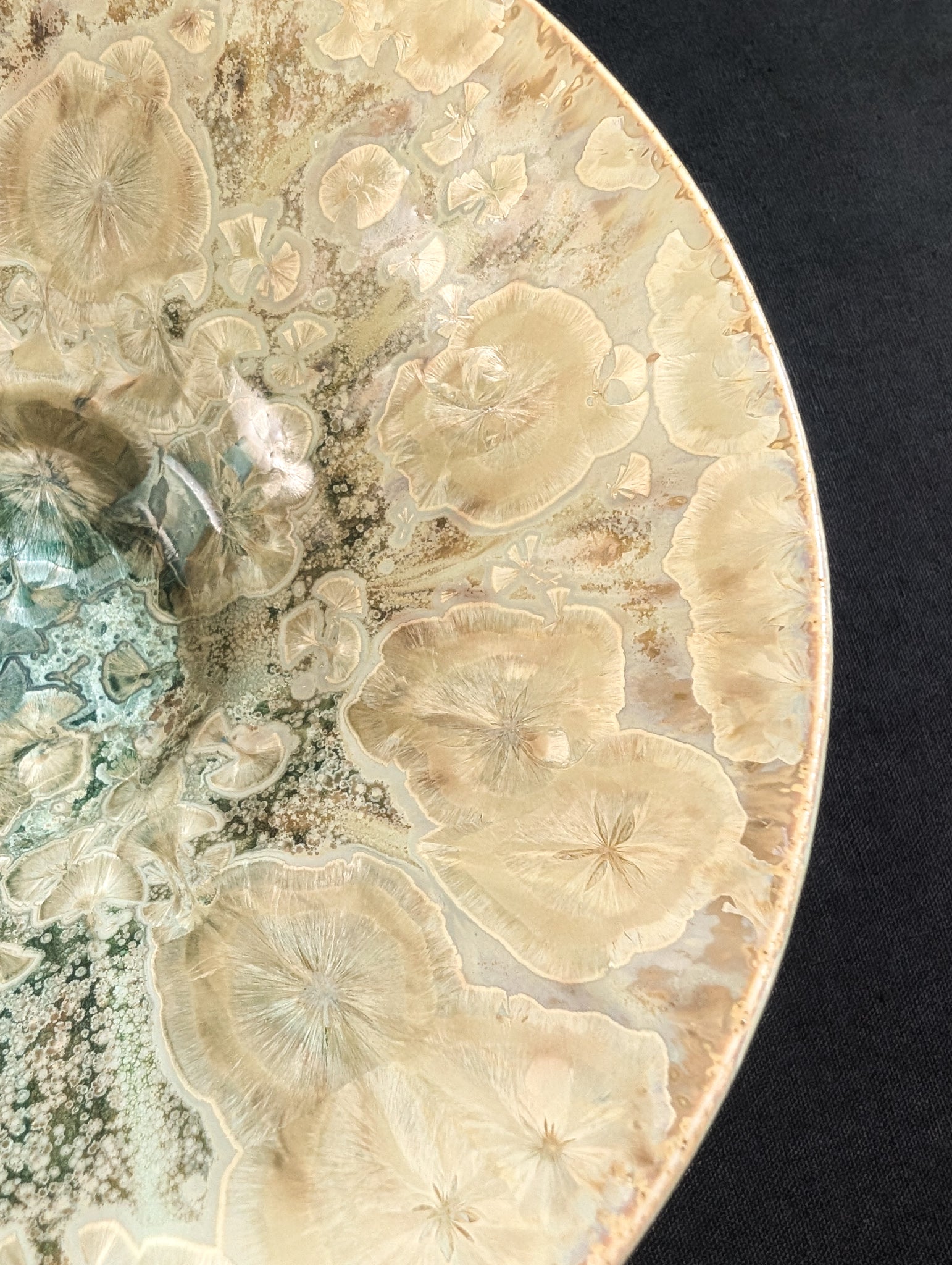 Close up shot of yellow crystals near the rim of a stunning treasure dish by ceramic artist Robbin Harris.