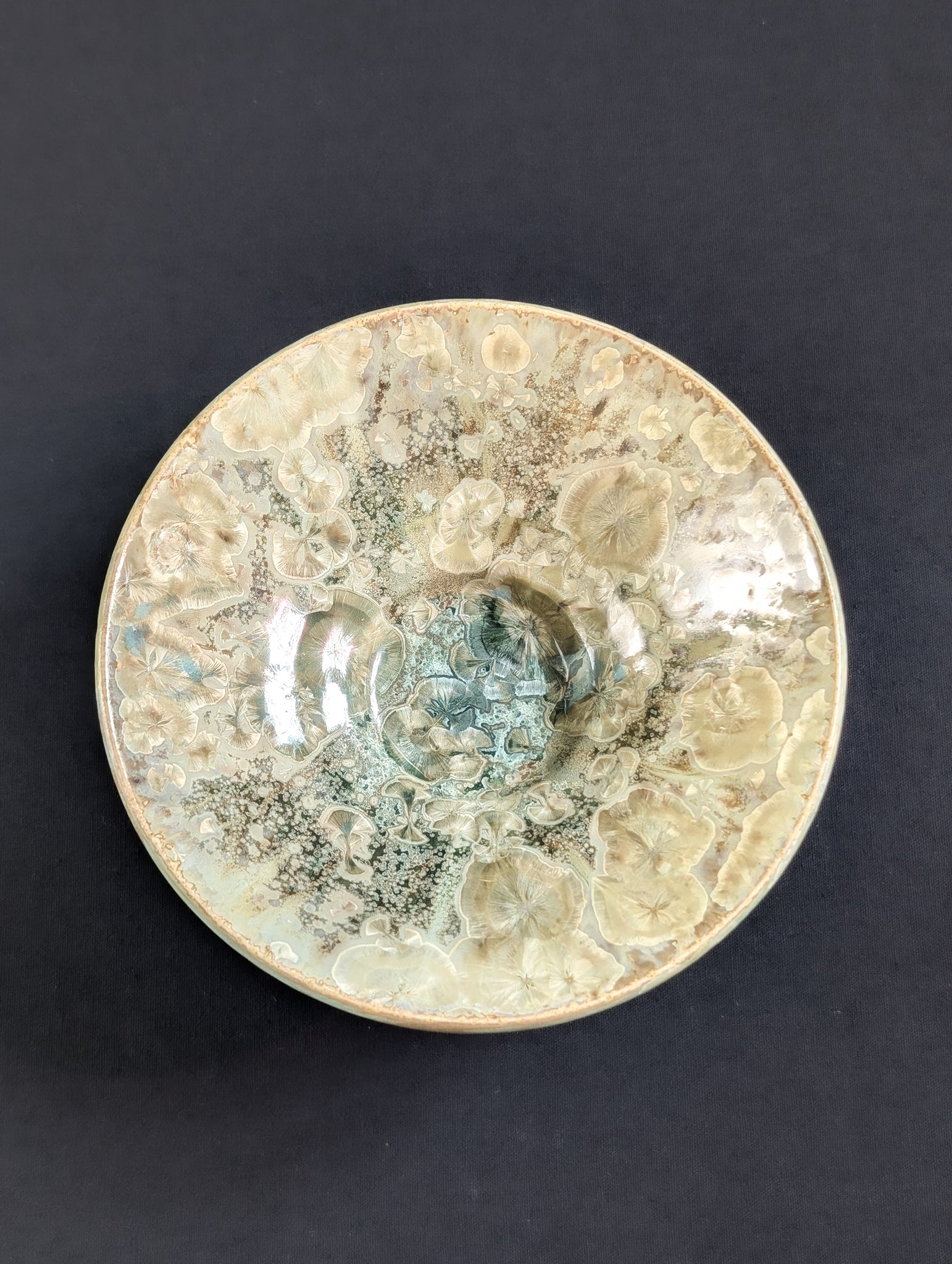 Decorative ceramic plate with intricate patterns on a dark background