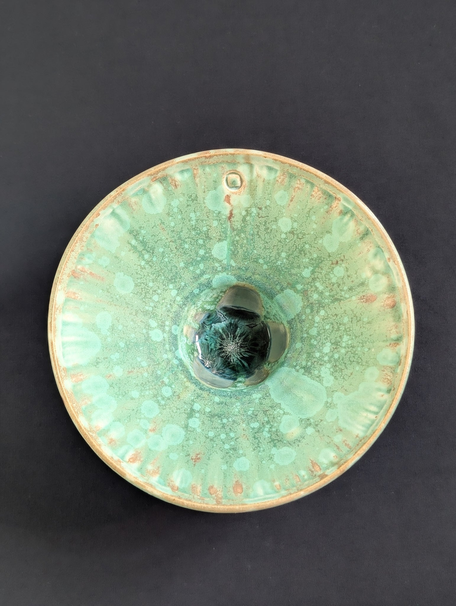 Top view of matte green crystalline ring dish by Robbin Harris.