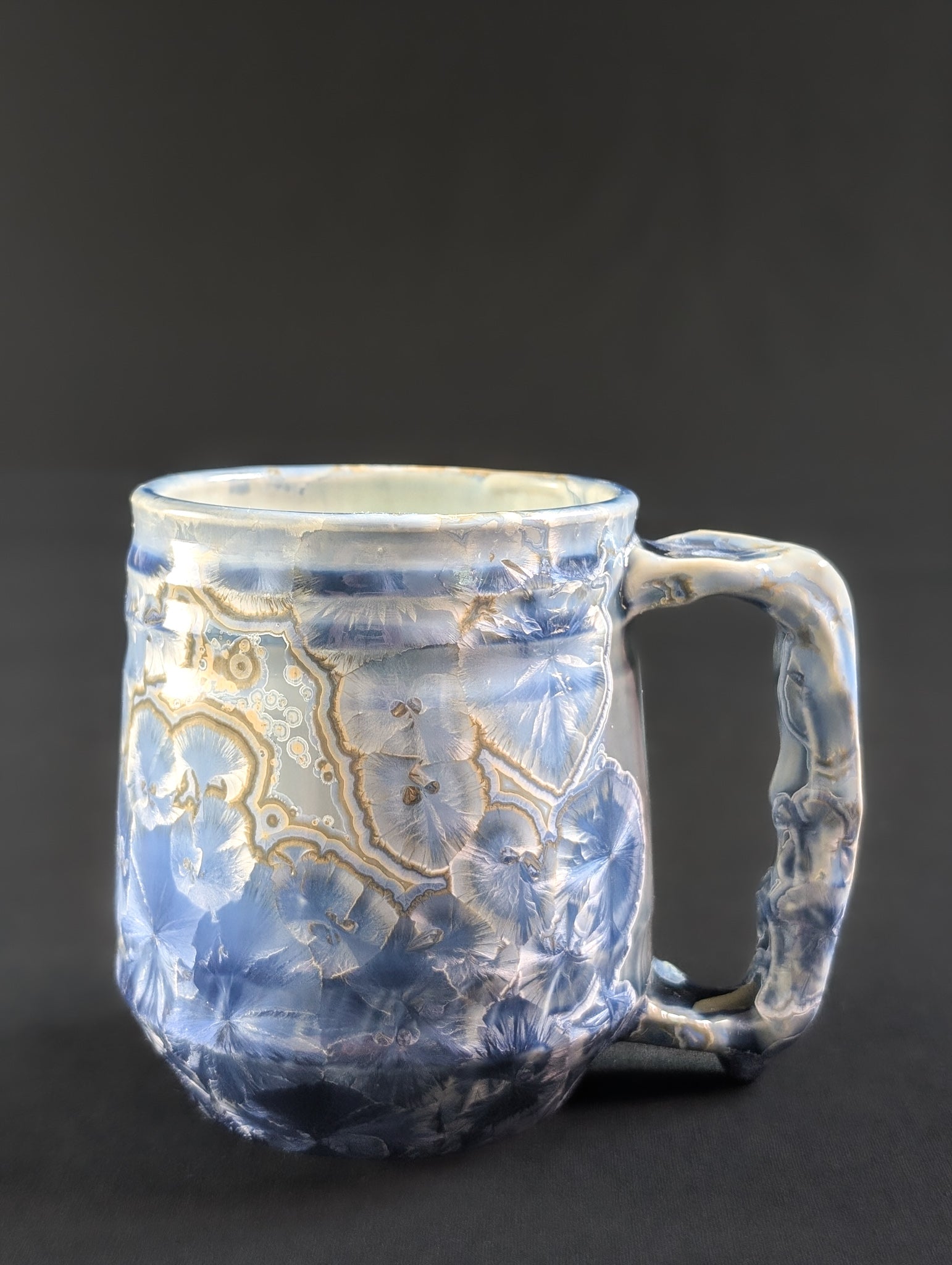 Side view of Celestial Atlas, showing the full texture of the handle and the sweeping pattern of blue and white crystals.
