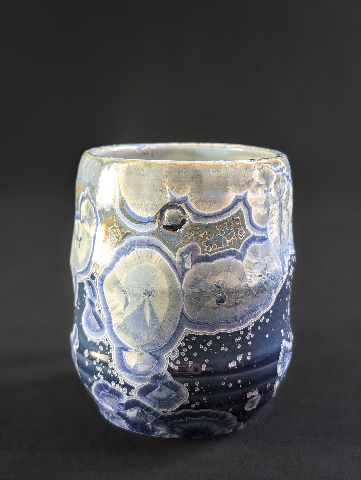 Celestial Tides mug front view in rich blue porcelain with white and gold-rimmed crystals.