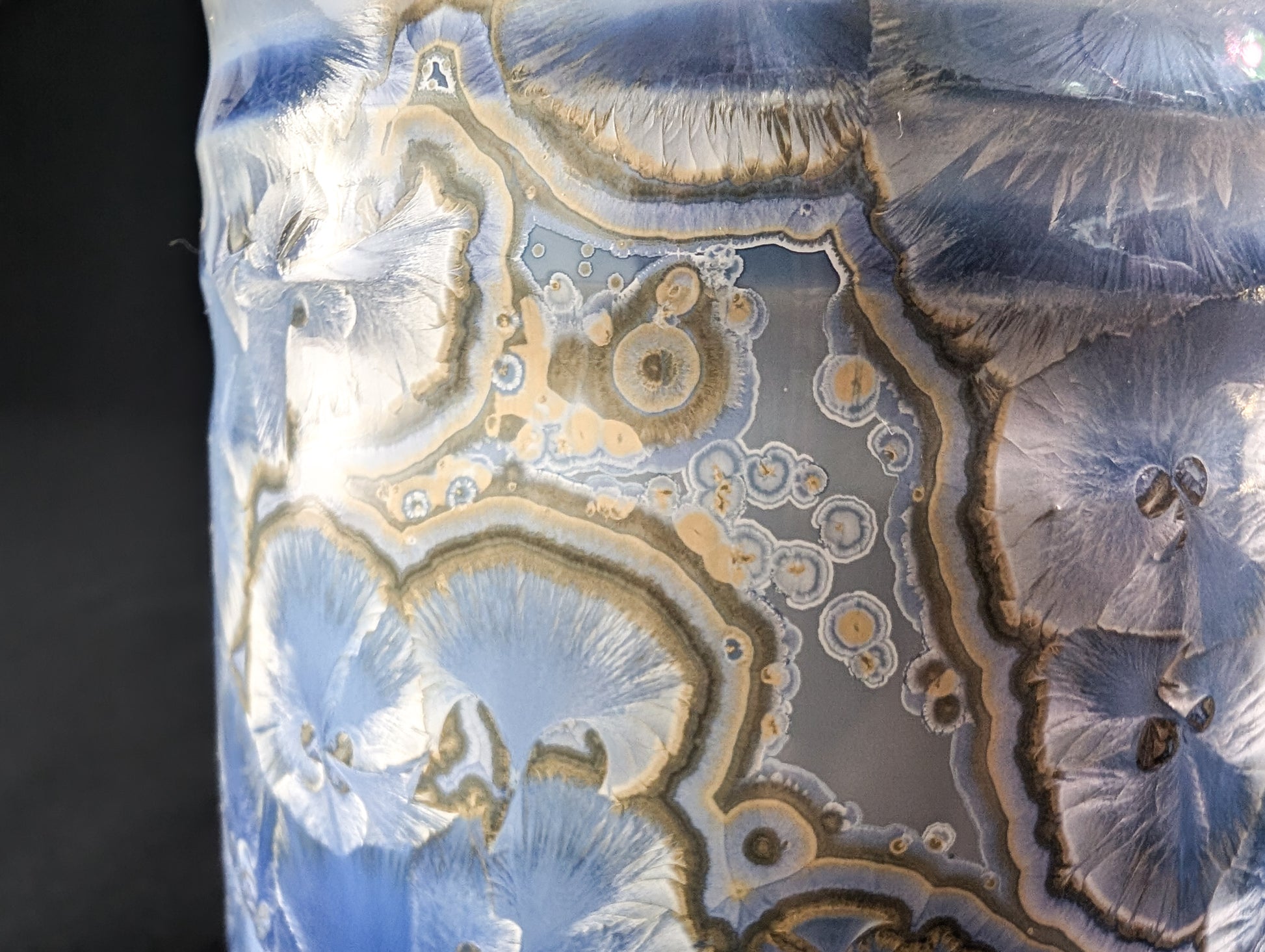 Detail of the crystalline glaze on Celestial Atlas, emphasizing large radial crystals with soft blue hues and gold edges.
