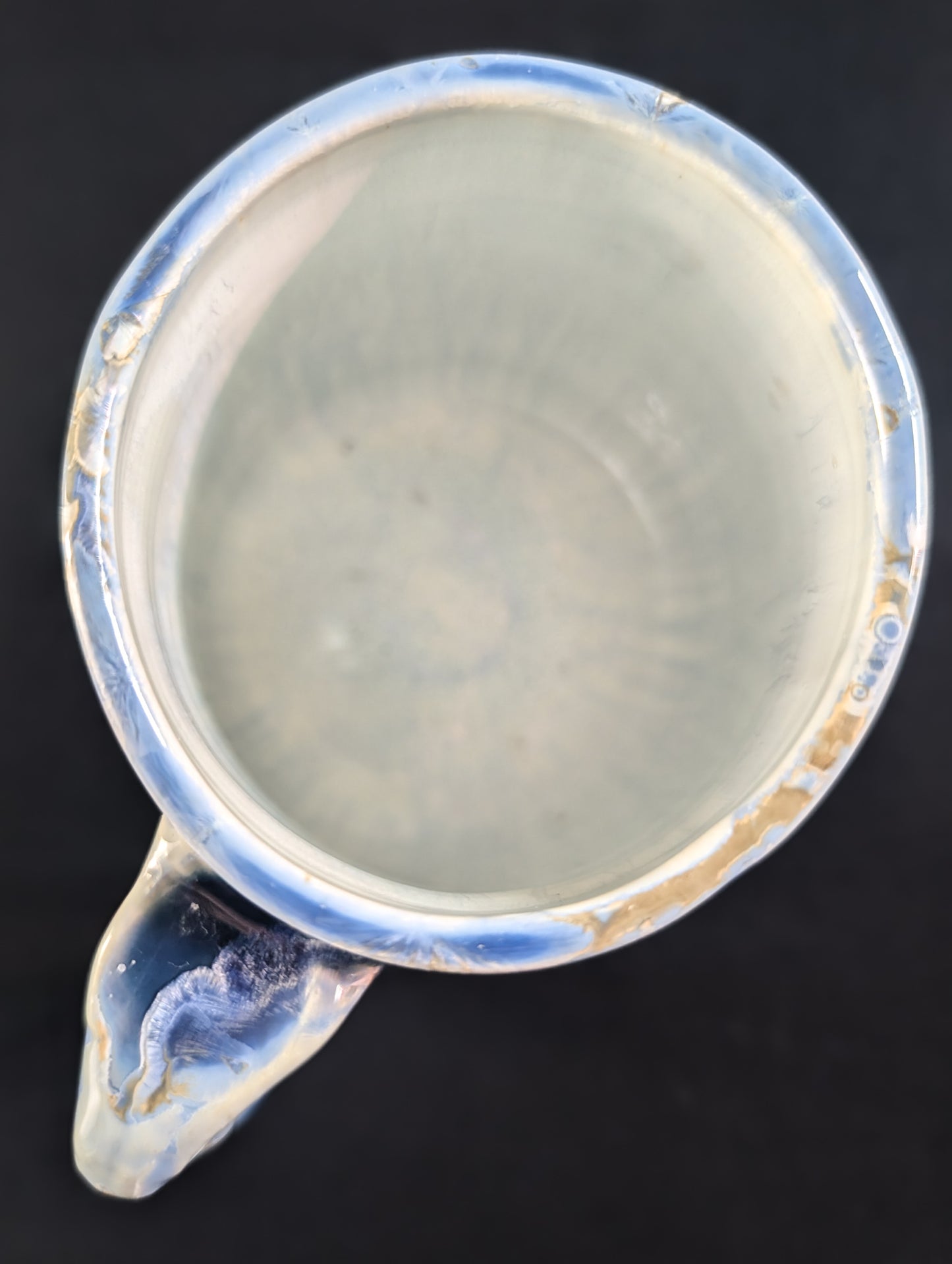 Top view of porcelain mug 'Celestial Atlas' showing white, food-safe liner glaze.