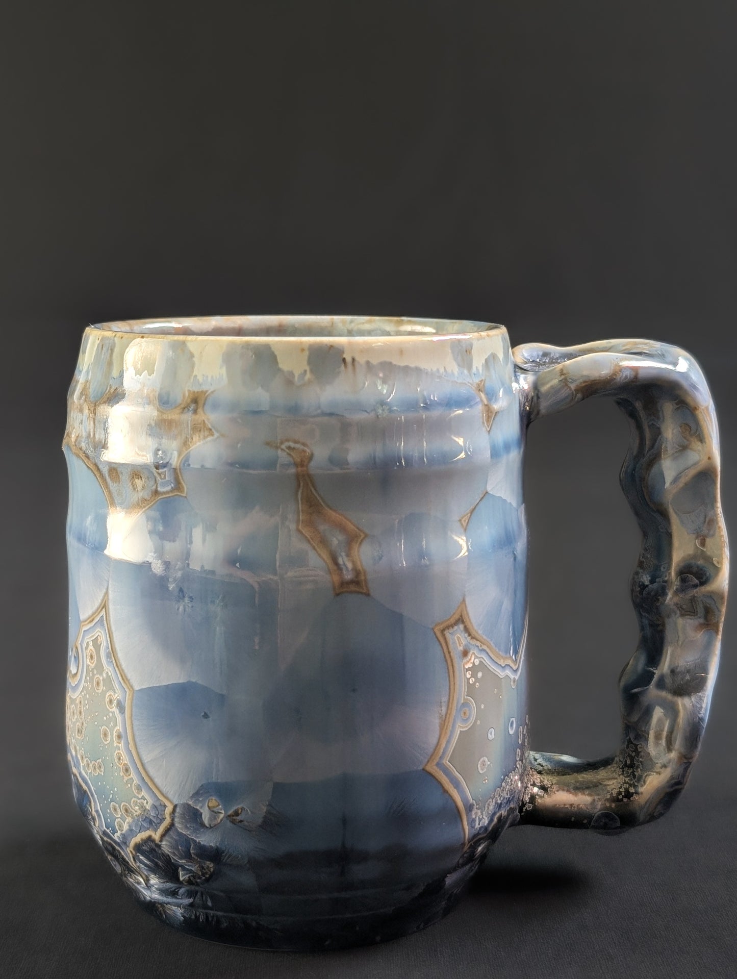 Side profile of Skydust, showing glimmering golden halo outlines around delicate crystals set in a serene, dusky blue background.