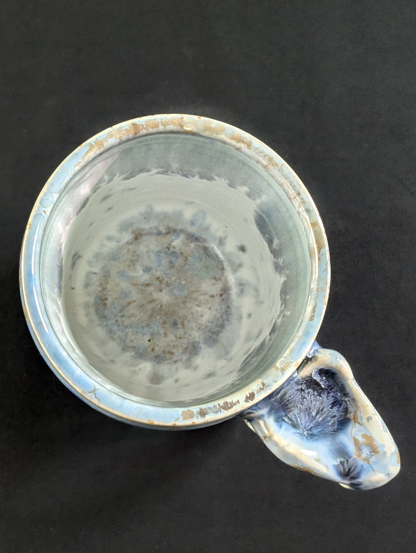Overhead view of Skydust, revealing a smooth white interior liner glaze and thick, rounded lip — the crystals stop cleanly at the rim.