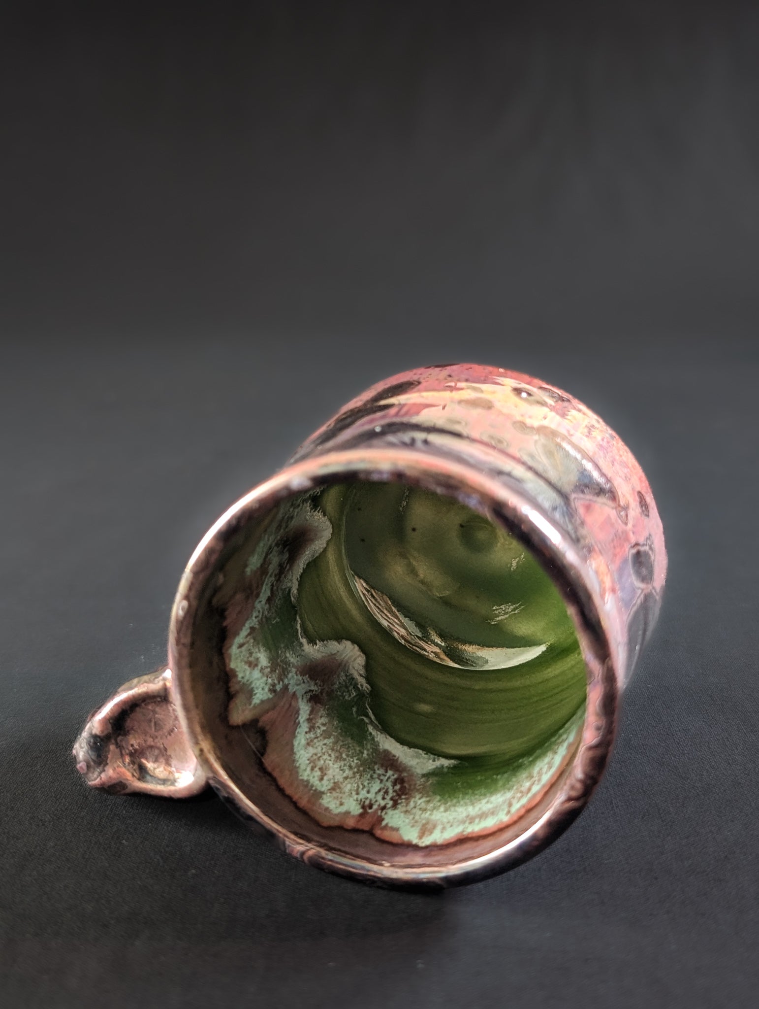 Overhead view showing the celadon green interior of the Pink Nebula mug.