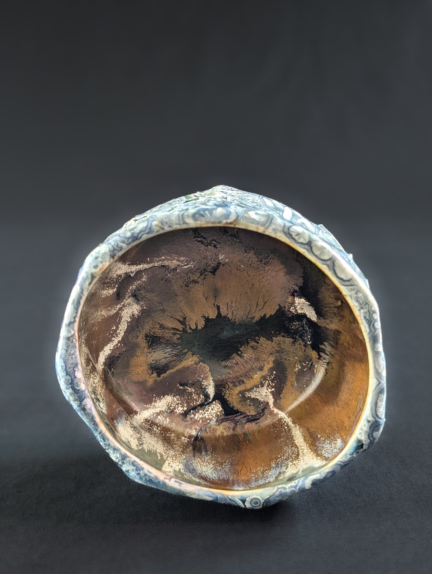 Top view of 'Firevein', revealing a glowing amber interior that contrasts with the cool, crystalline exterior.