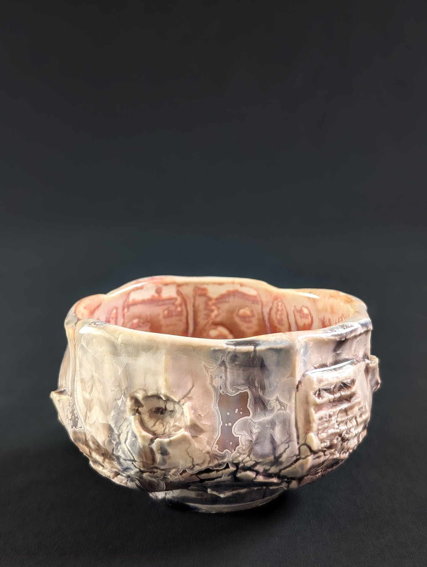 Porcelain tea bowl with textured surface on a black background