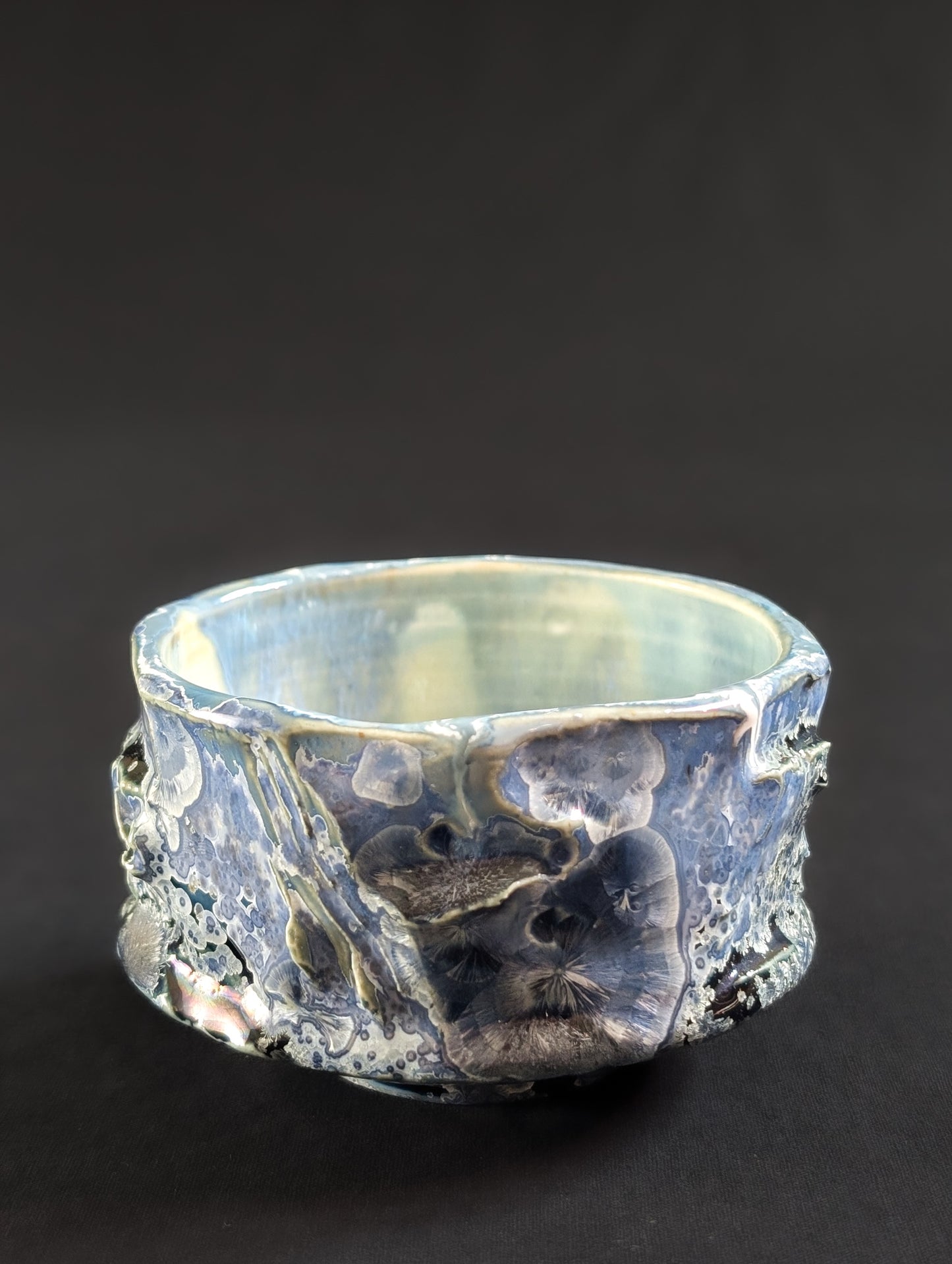 Profile of the 'Nightsky' tea bowl, where the glaze surface looks almost windswept beneath layers of floating light-blue crystals.