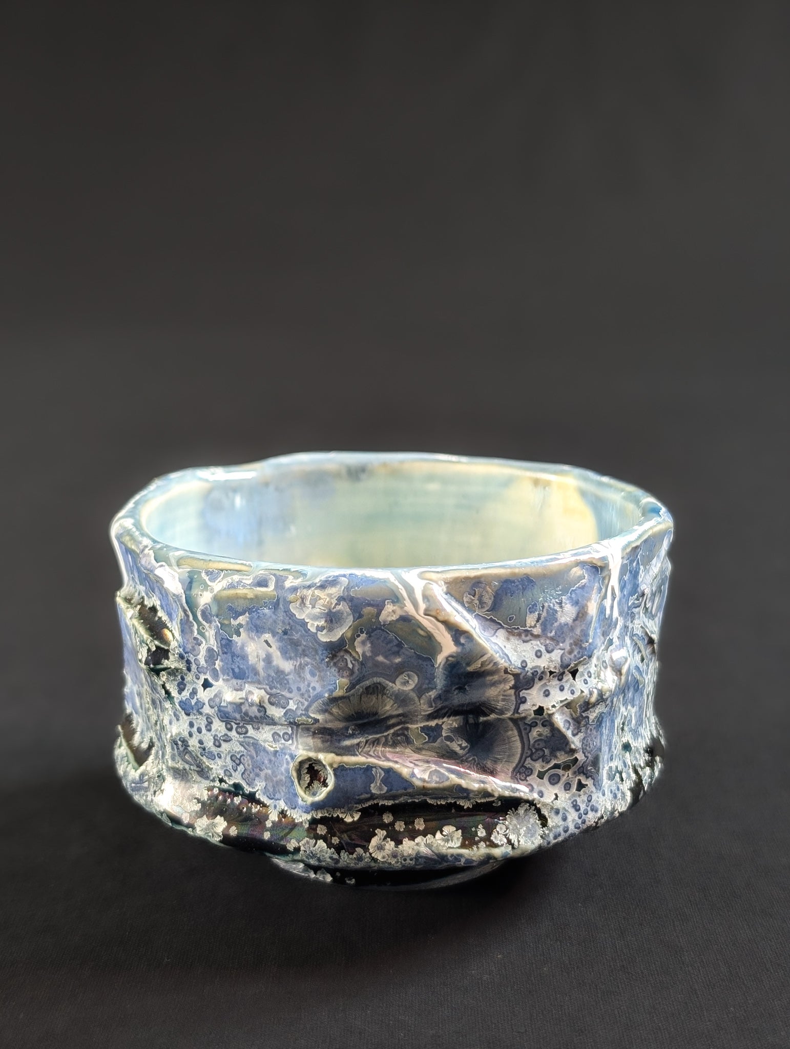 Side view of 'Nightsky' chawan, highlighting the textured surface and scattered crystalline patterns.