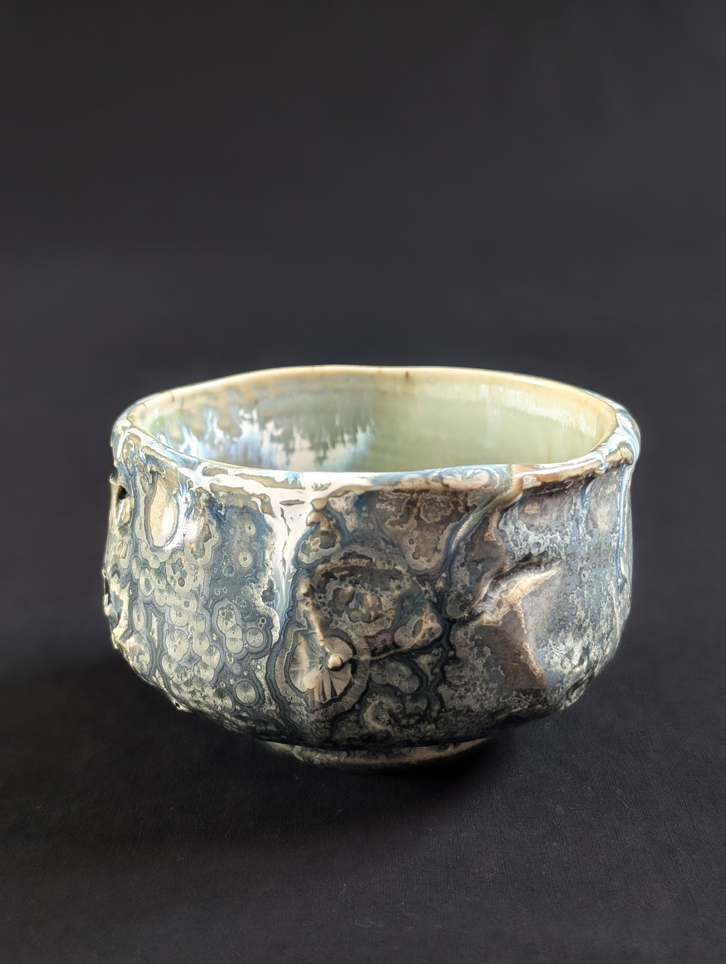 Ceramic bowl with textured surface on a black background