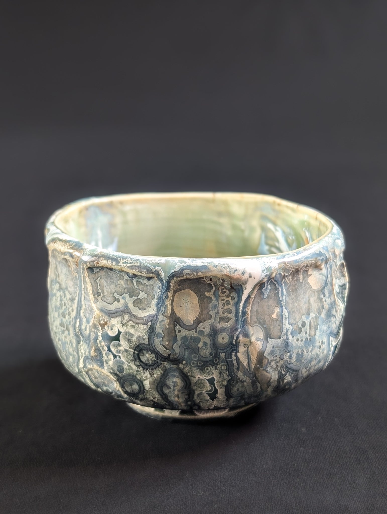 Ceramic bowl with textured surface on a black background