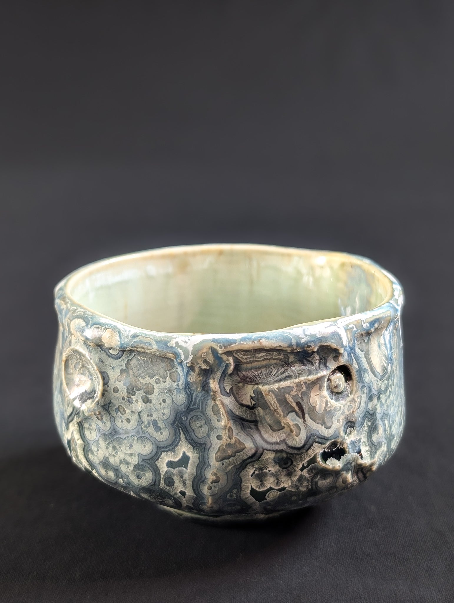 Ceramic bowl with intricate patterns on a dark background