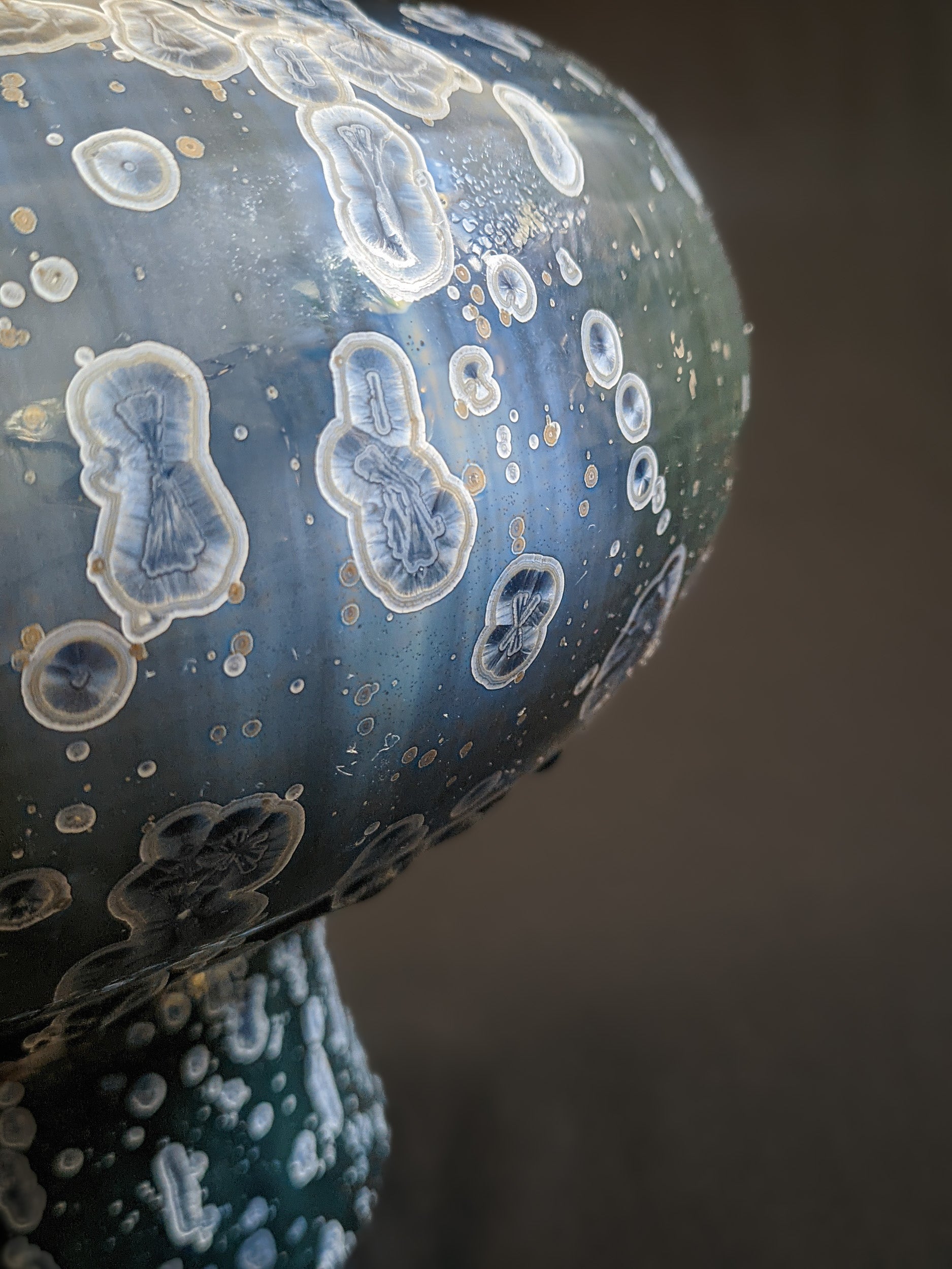 Angled side view of Majestic Verdance, capturing the dynamic play of light on the crystals.