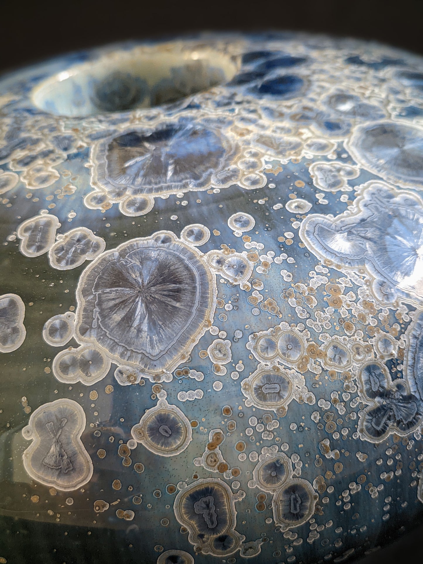 Close-up of Majestic Verdance’s surface, showcasing intricate crystal patterns with hints of gold and white.