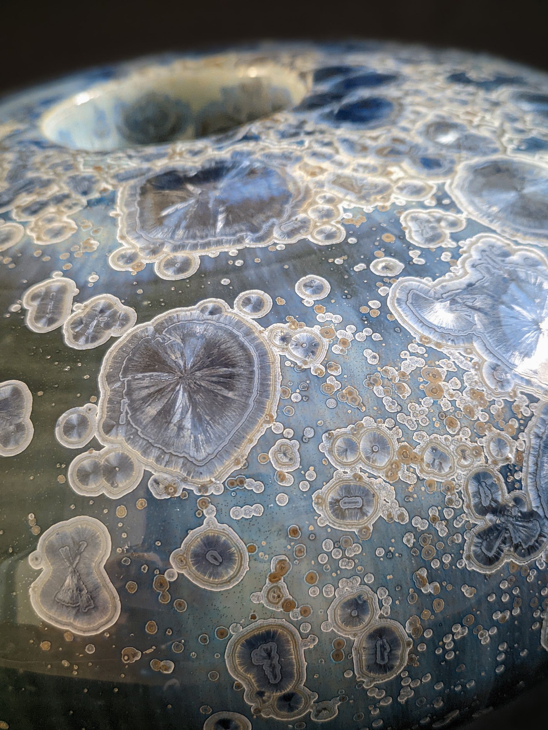 Close-up of Majestic Verdance’s surface, showcasing intricate crystal patterns with hints of gold and white.