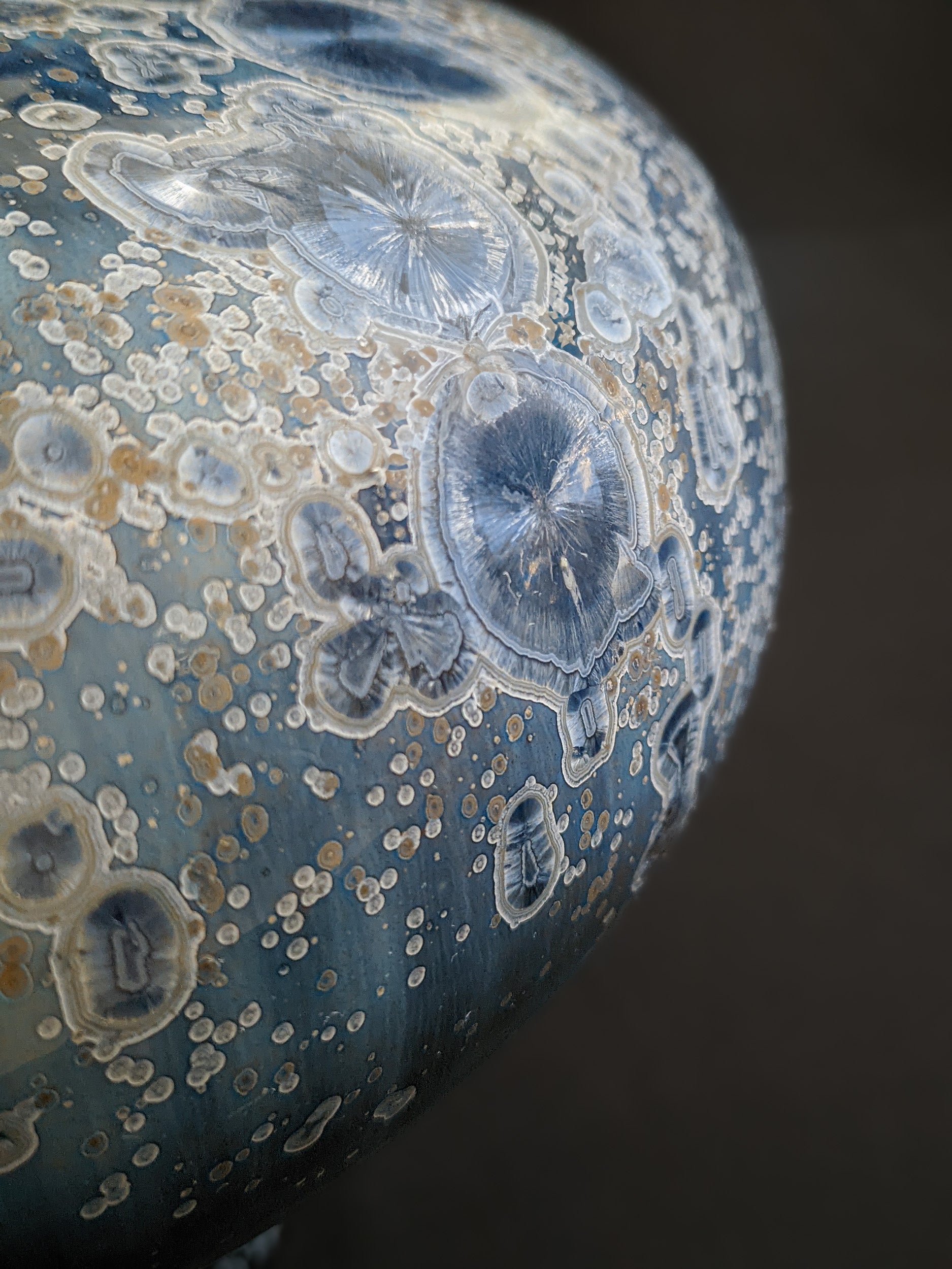 Close-up of Majestic Verdance’s surface, showcasing intricate crystal patterns with hints of gold and white.