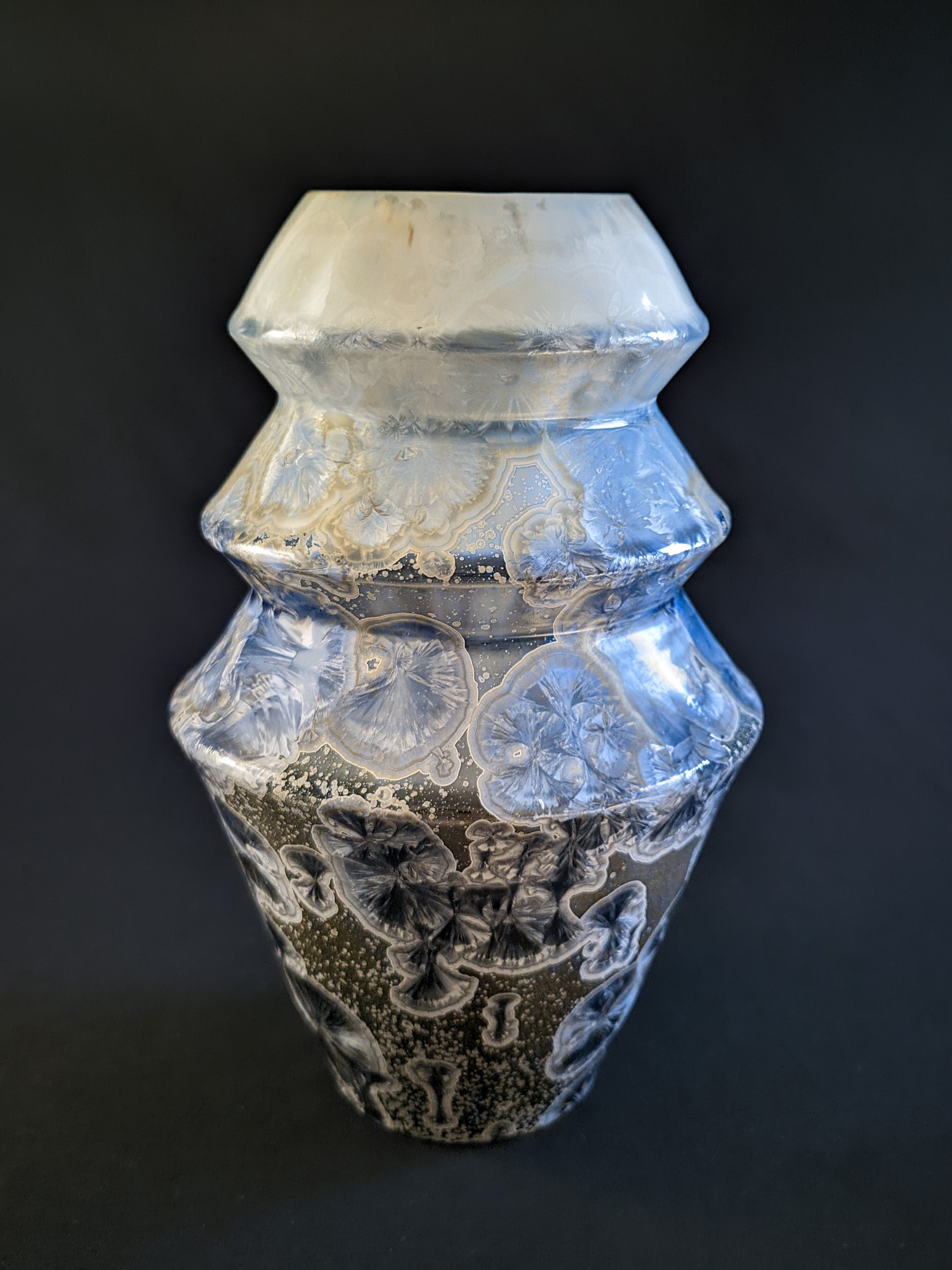Front view of the Frozen Serenity vase featuring its delicate gradient glaze, transitioning from dark blue at the bottom to pale cream, with intricate crystal formations scattered across the surface