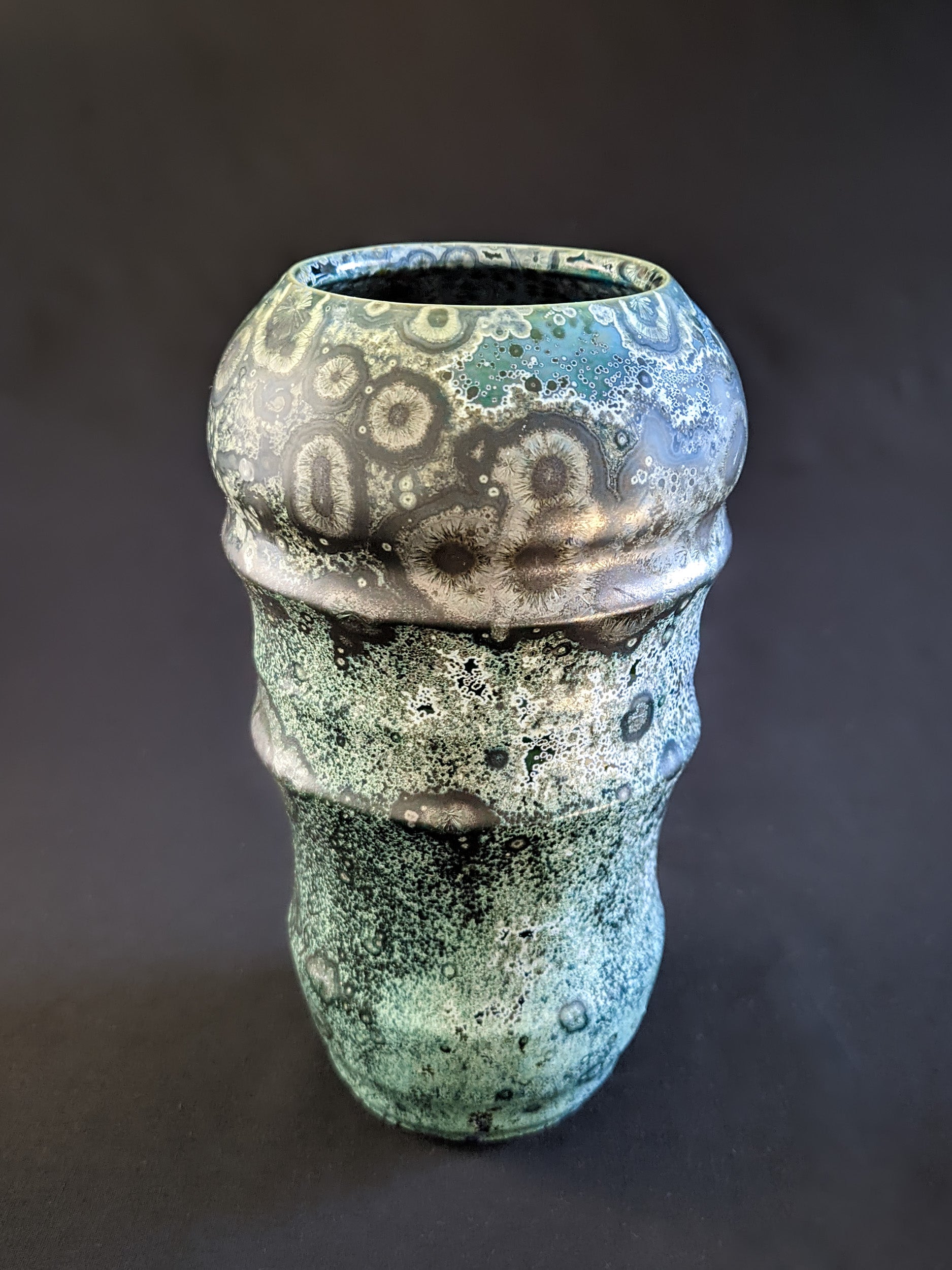Emerald green crystalline-glazed vase with over crystallized surface showing thousands of tiny secondary white crystals. 
