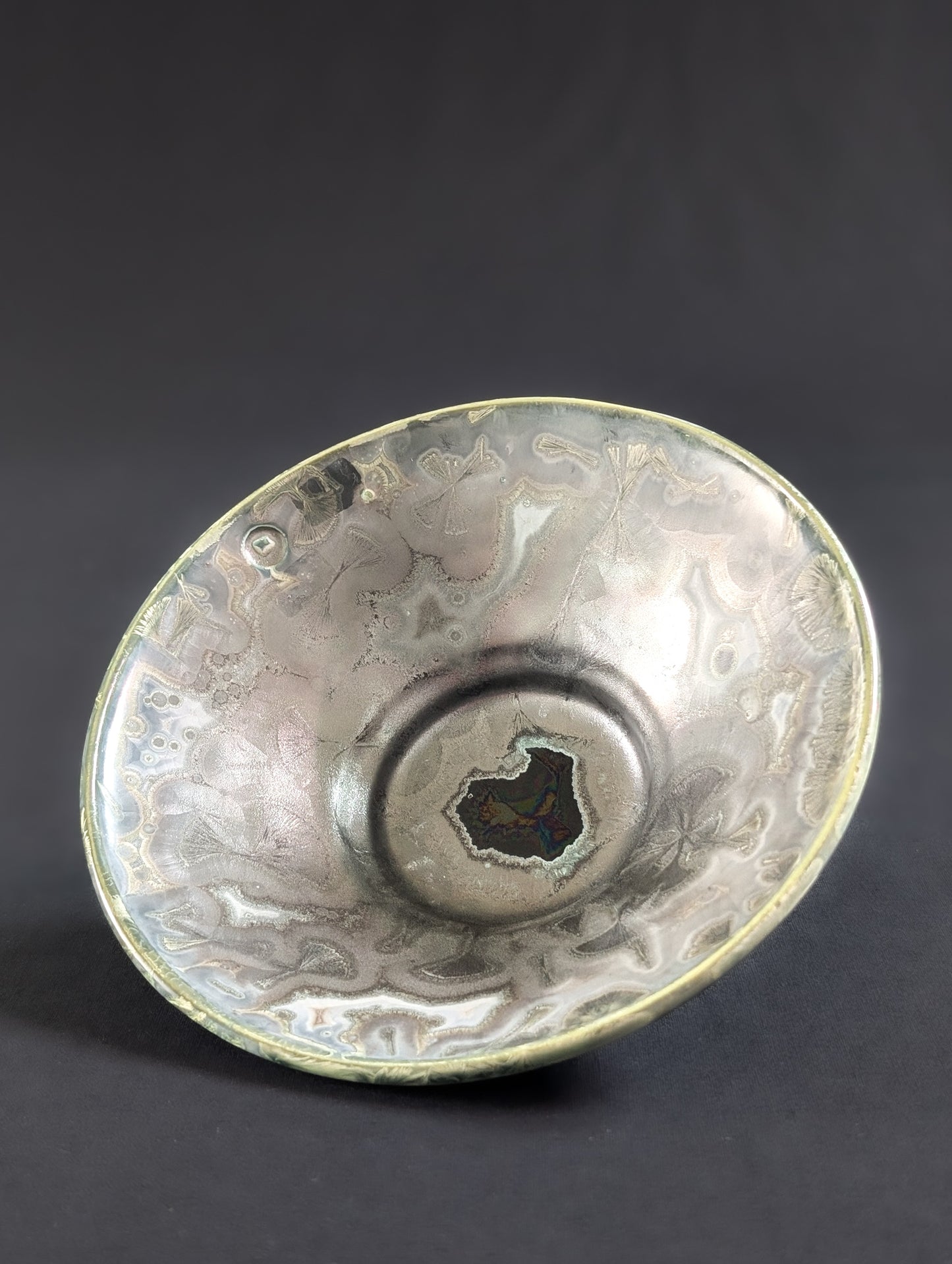 Decorative porcelain bowl with intricate patterns on a dark background