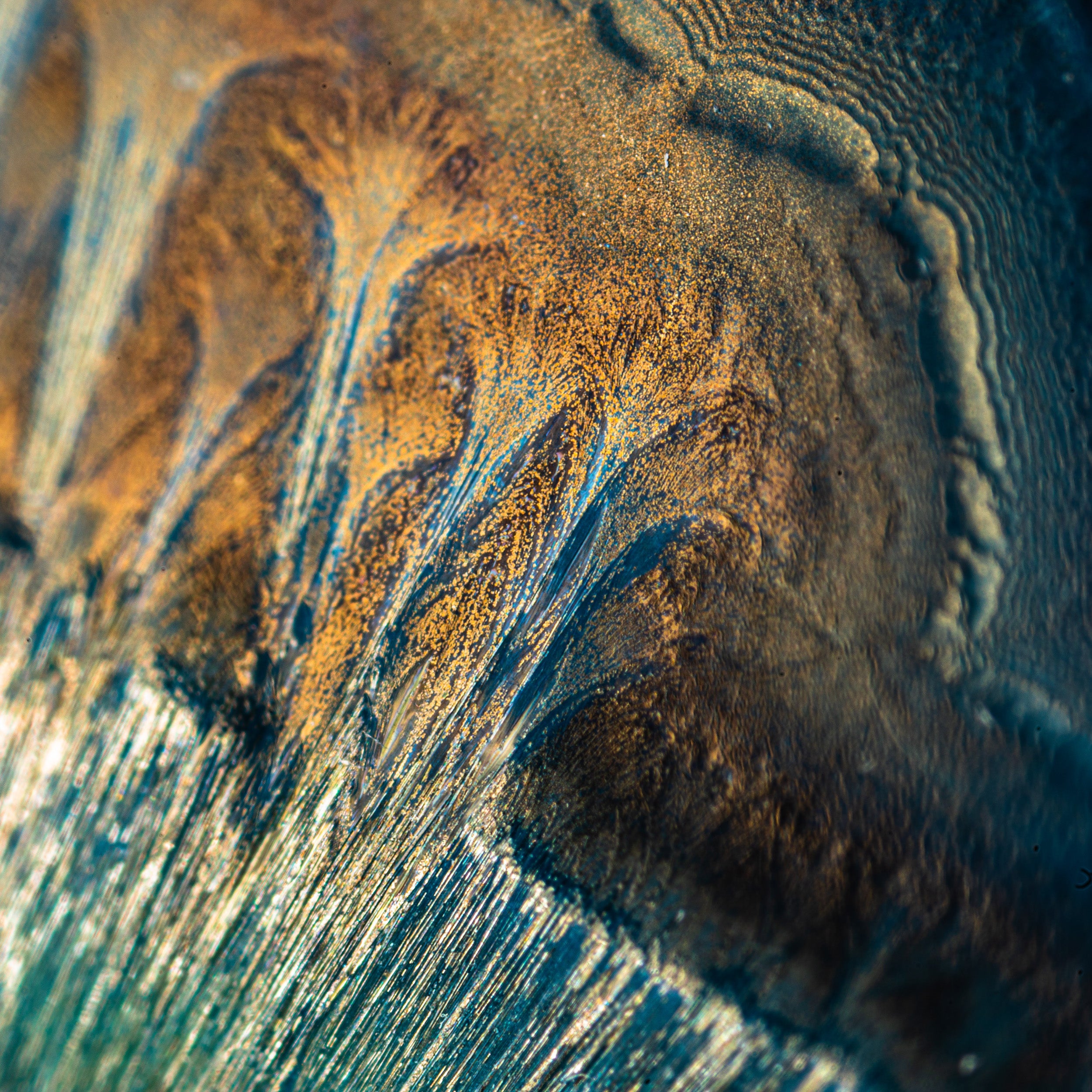 Tan crystalline glaze in extreme close-up, revealing organic, sunlit patterns that shimmer with texture and depth. Photographed by Kelly Hofer.