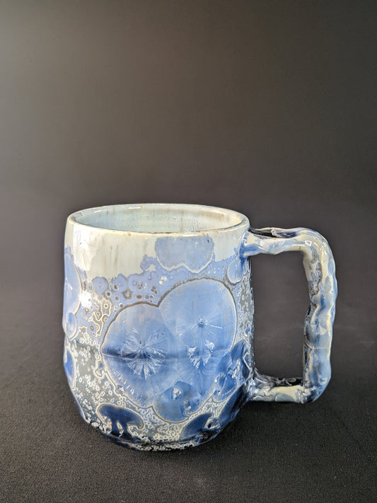 Handcrafted Glacial Echo Mug with a serene icy blue glaze, showcasing intricate frost-like textures, creating a cool, refreshing feel perfect for any drink.