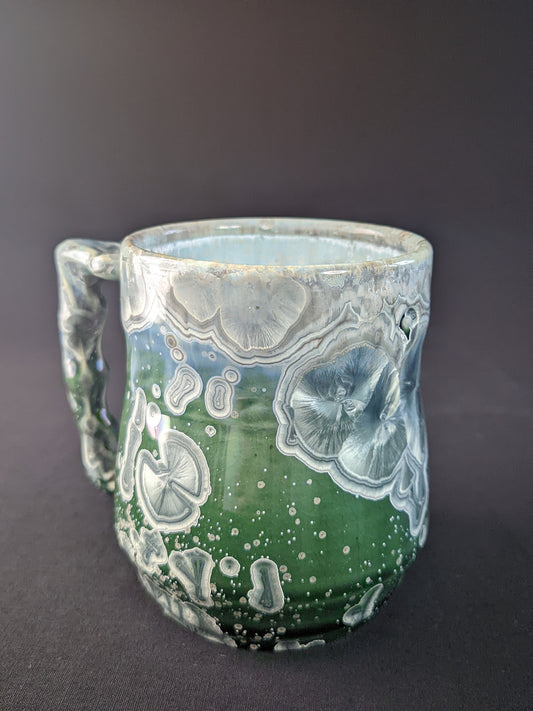 Handcrafted Aurora's Embrace Mug featuring a striking blend of deep blues and purples, with delicate patterns inspired by the Northern Lights, and a smooth, ergonomic handle for a comfortable grip.