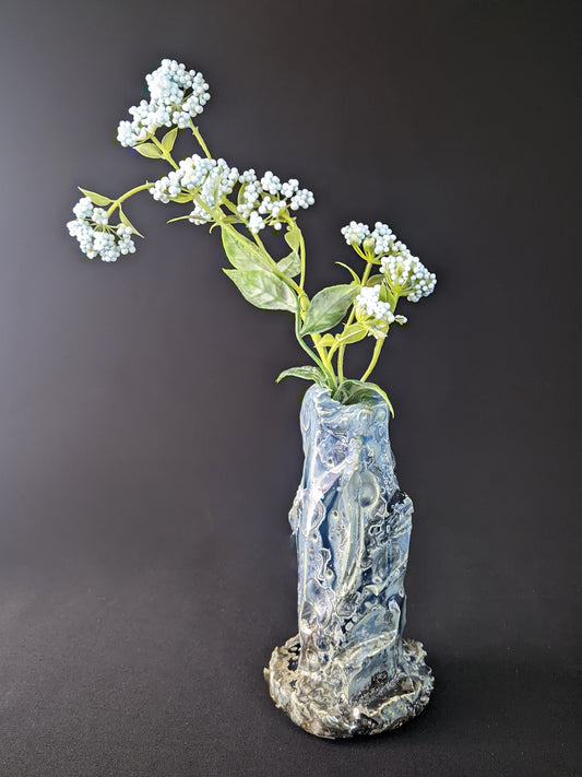 Elegant Ice Bound Single Flower Vase with cool, frosty blue and white tones, showcasing a smooth, glossy surface and an organic, tapered shape, set against a dark backdrop.